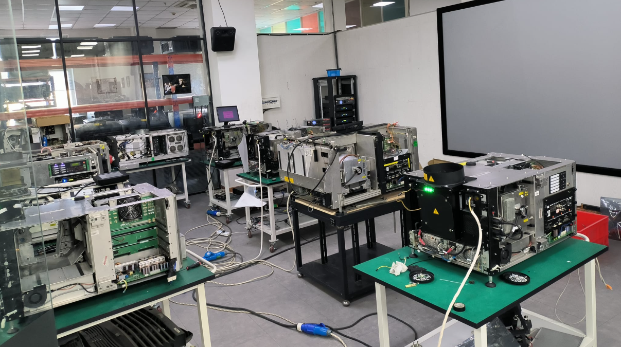 Barco projector repair workshop with multiple projectors under repair in ESD-safe clean-room conditions